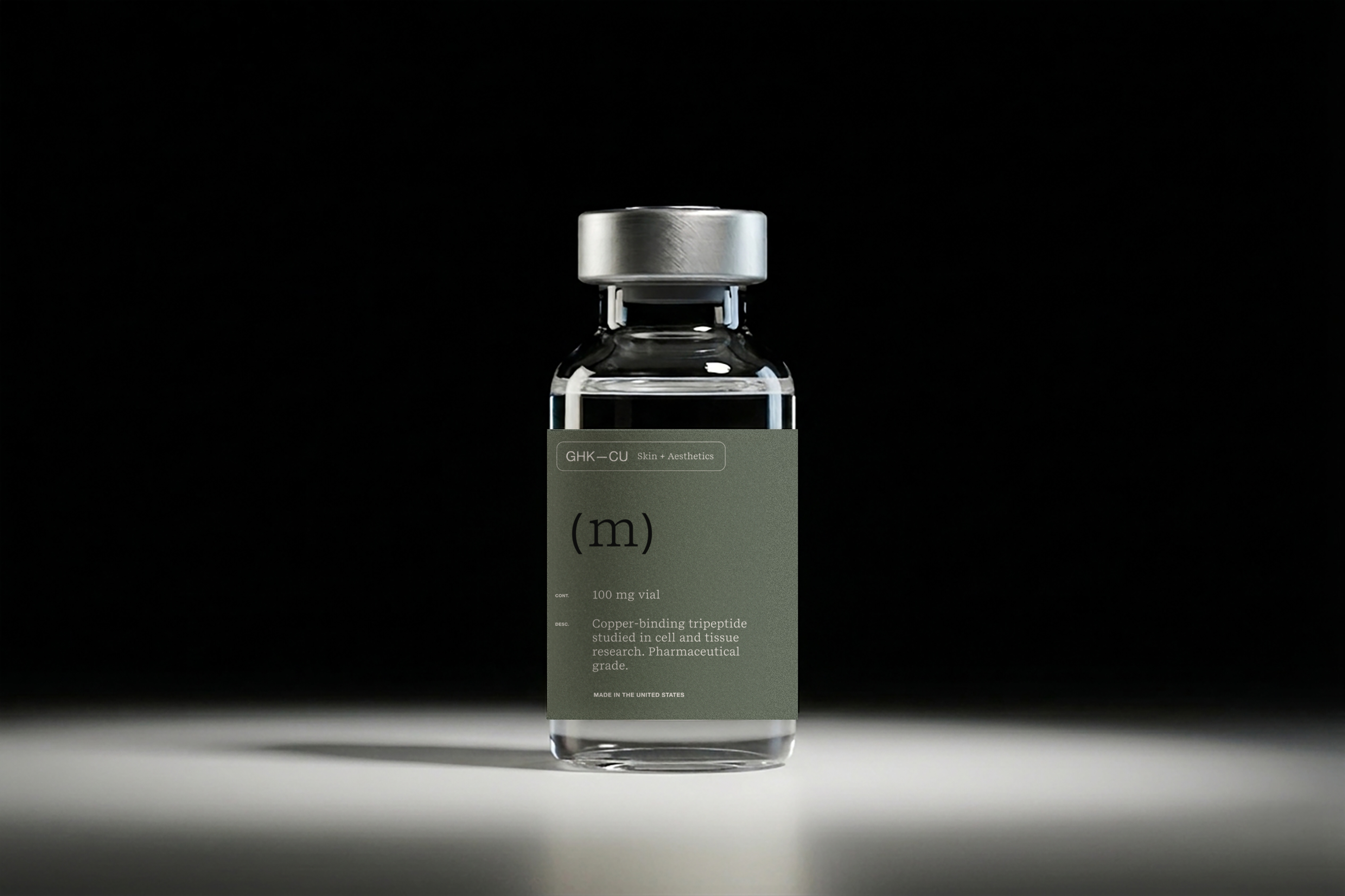 Mino GHK-Cu vial with a sage green label under studio light